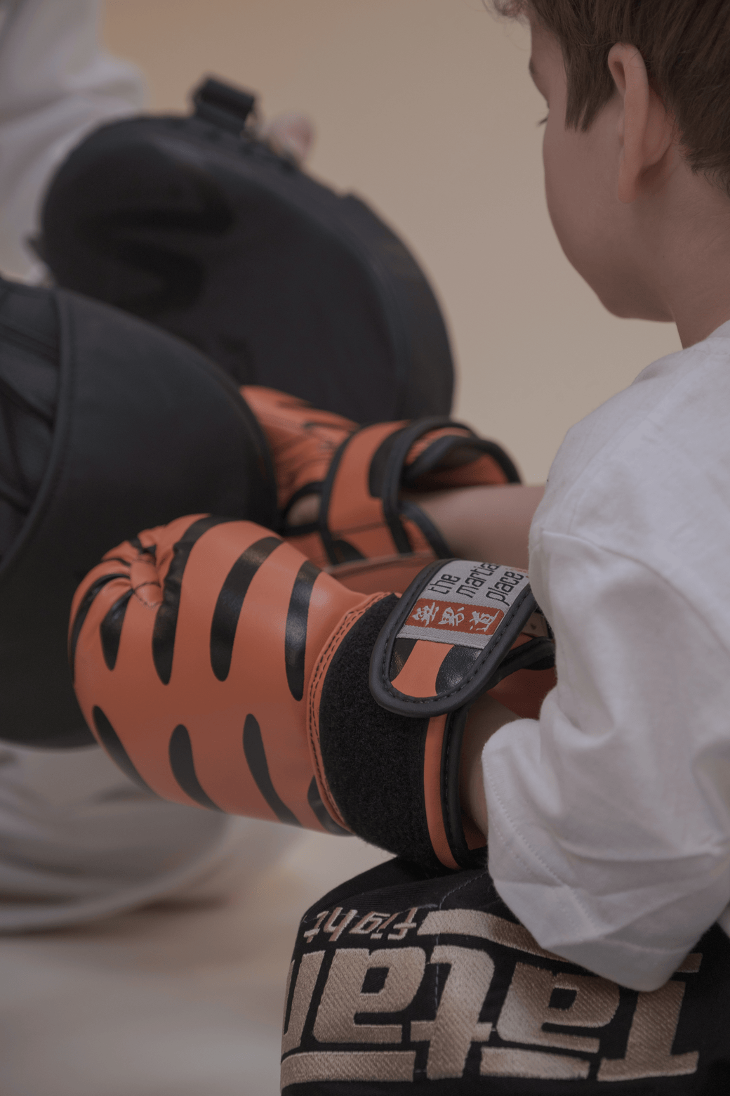 Young child with kickboxing shin guards at Notting Hill Club
