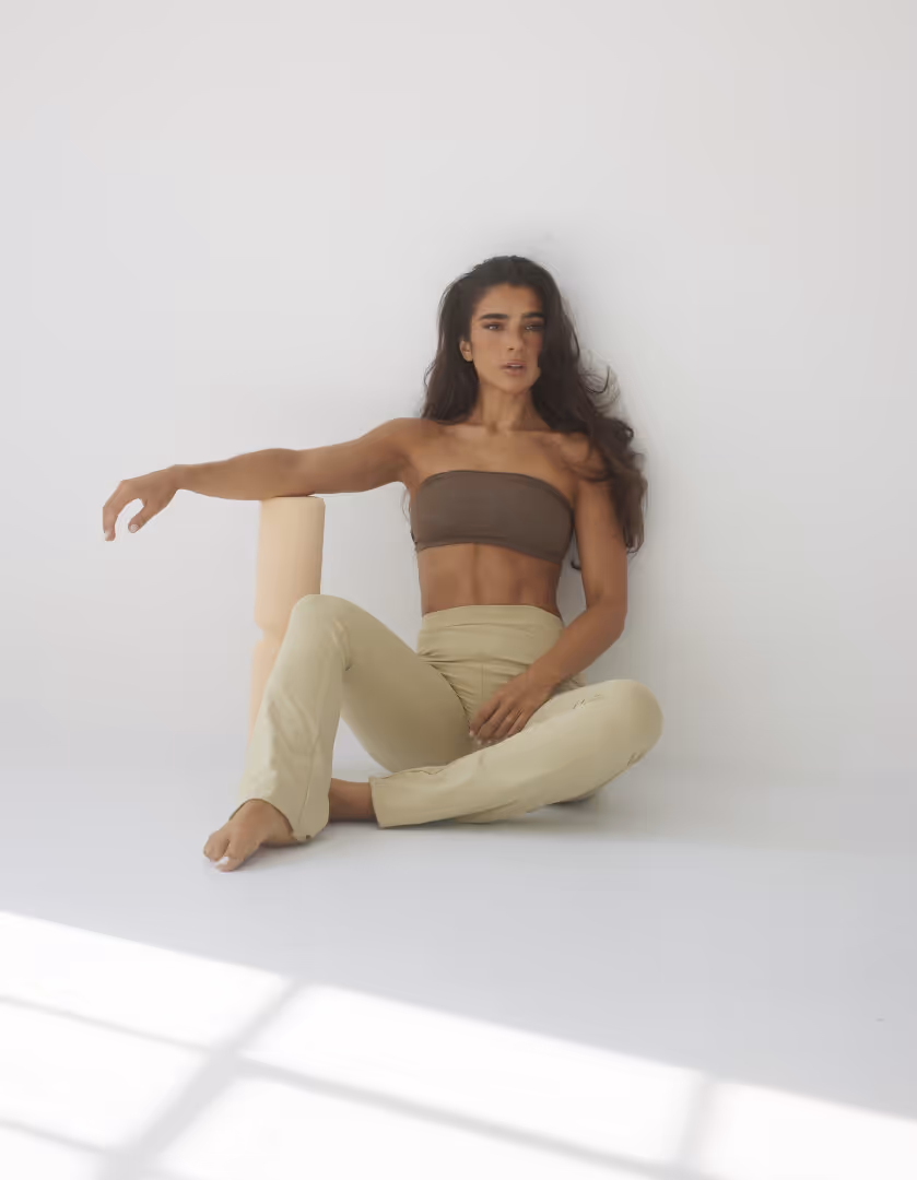 Stef Williams of WeGLOW Fitness App for women sitting in SEFI workout gear for hybrid training