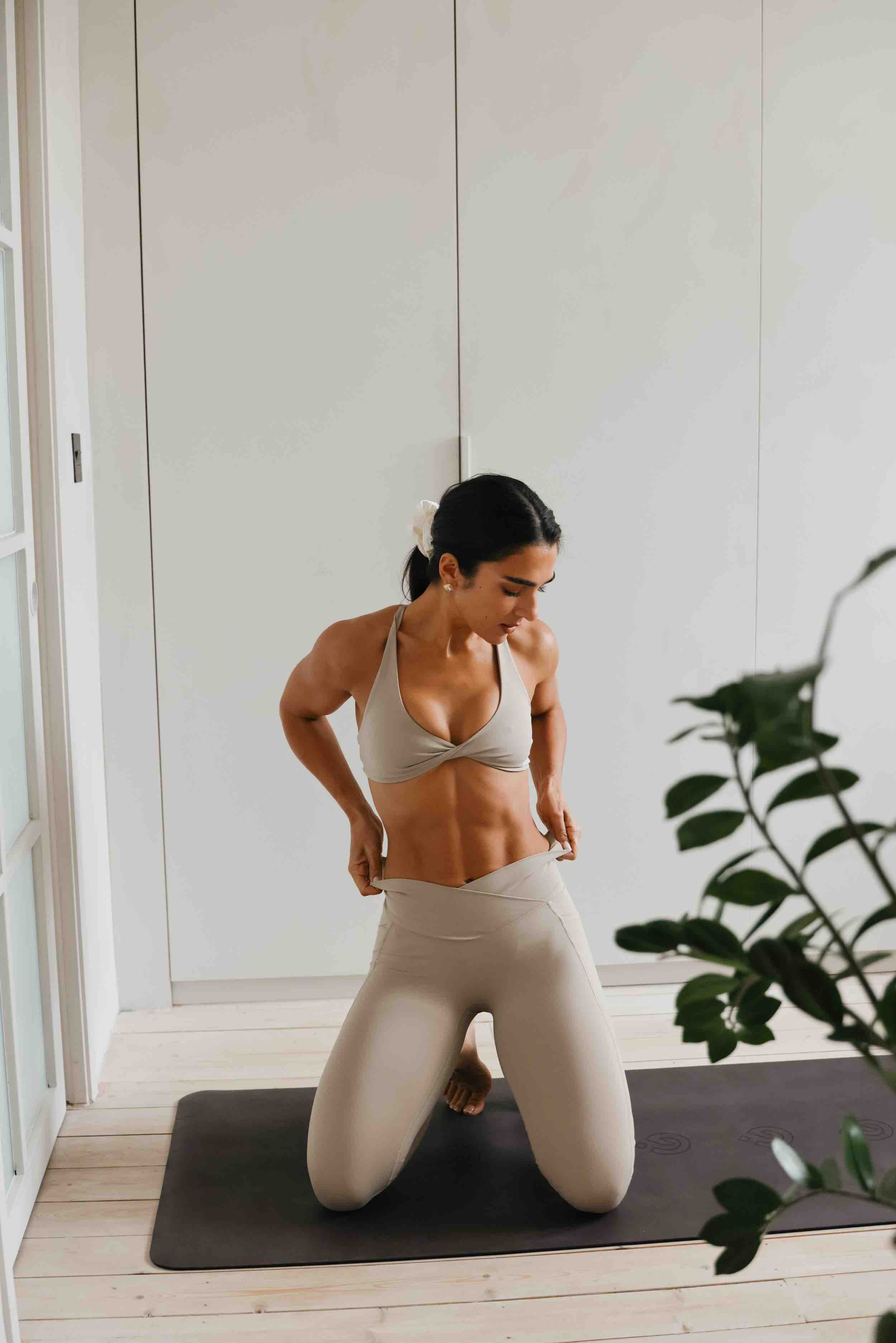 Stef Williams on a Pilates workout mat with Pilates equipment