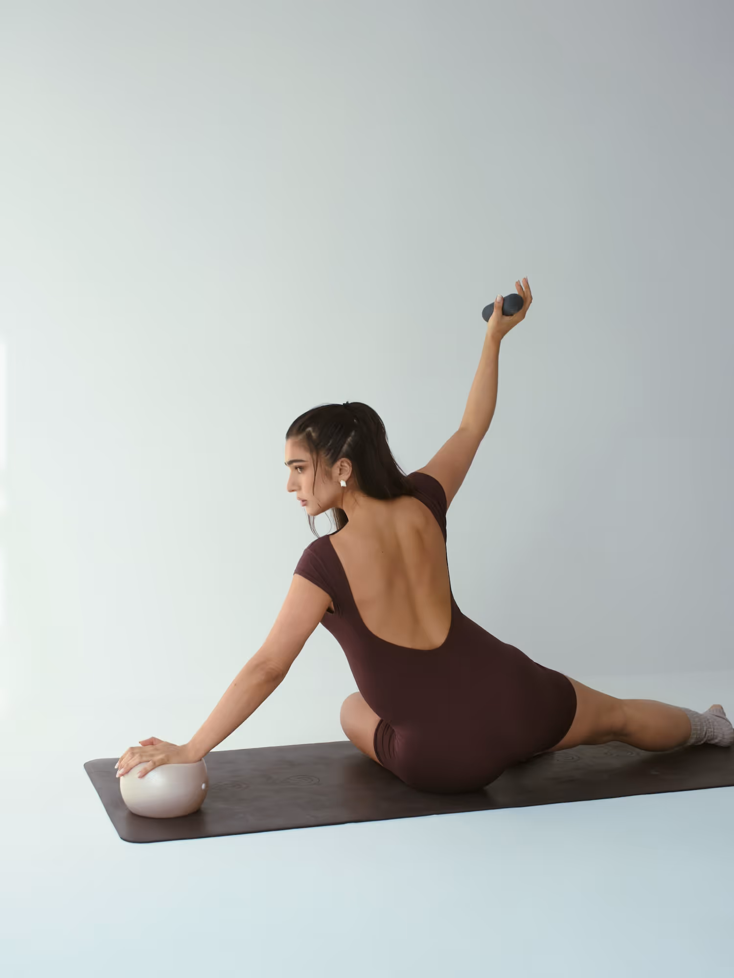 A female fitness trainer is demonstrating the best exercises for working out on your period.