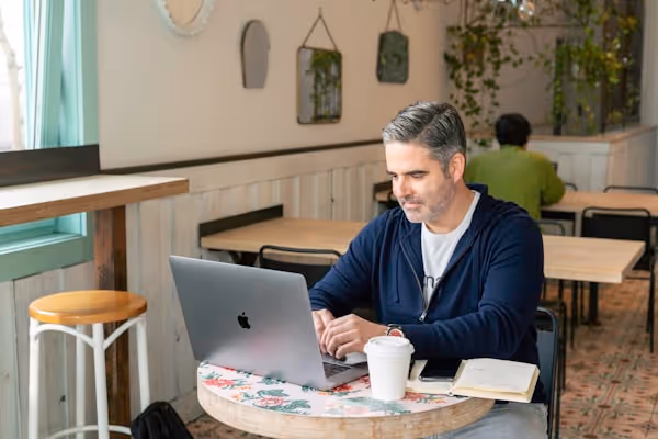 A salesperson working in an cafe/coffee shop on a virtual call