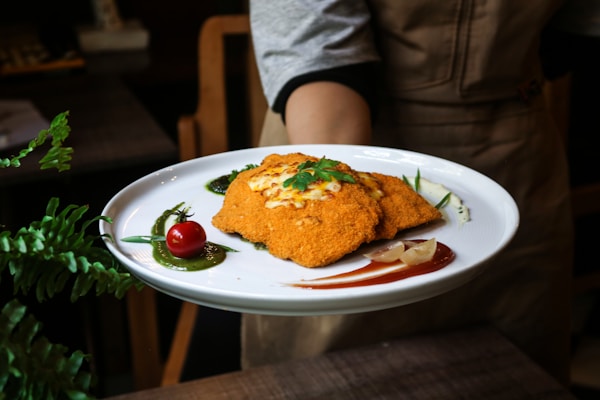 a person holding a plate with food on it