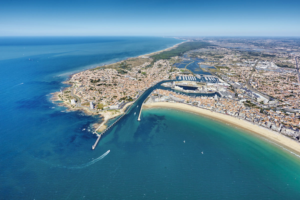 Aerial view of the town, its harbor, and the seafront promenade.