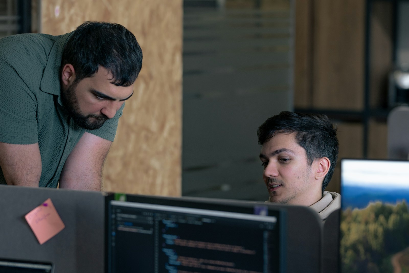 Two developers reviewing code together at computers