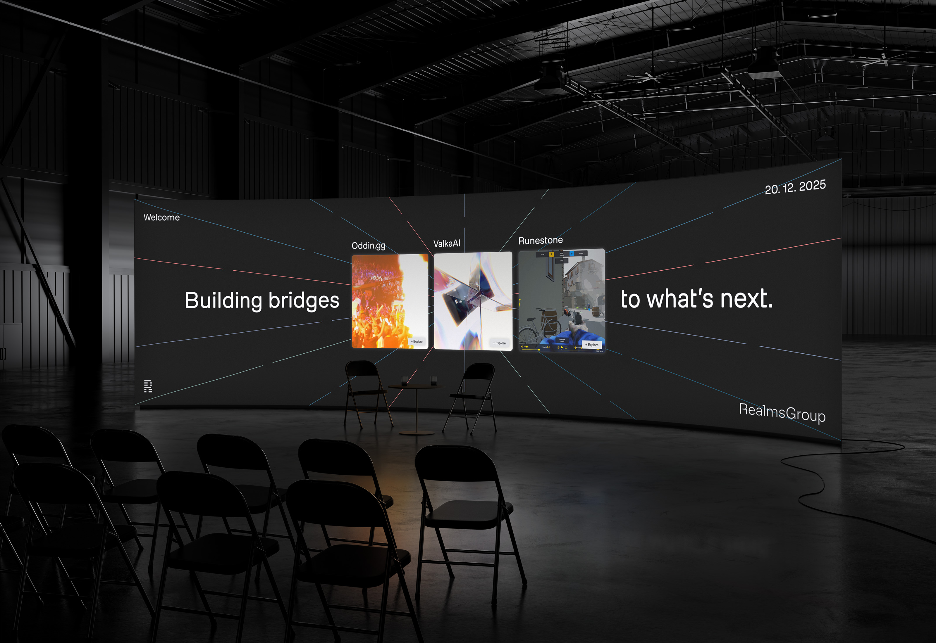 Dark warehouse with a large curved screen displaying 'Building bridges to what's next' and three project cards labeled Oddin, ValkaAI, and Runestone; folding chairs and a small table are in front.