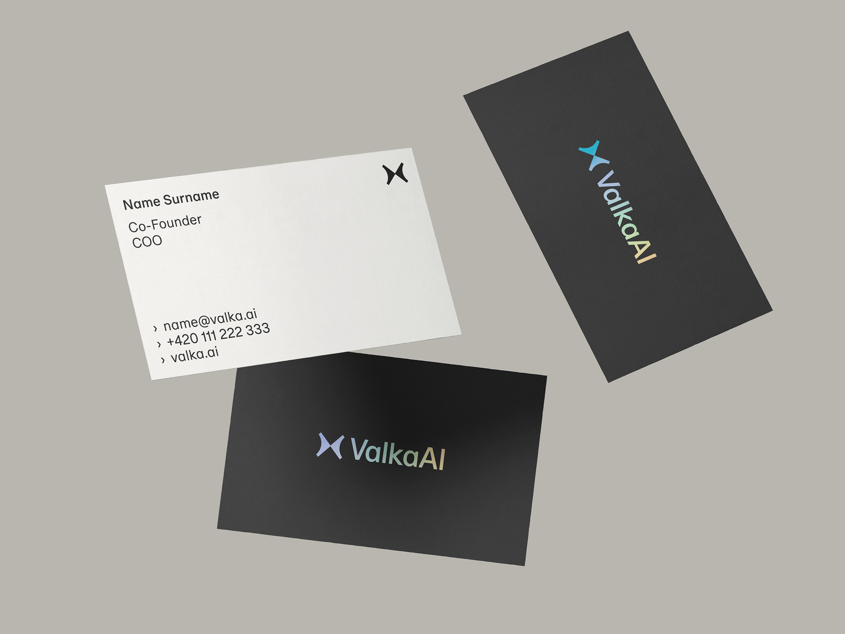 Three business cards for ValkaAI, one white with contact details for Milos Lokajicek, Co-Founder and COO, and two black cards with the ValkaAI logo in gradient colors.