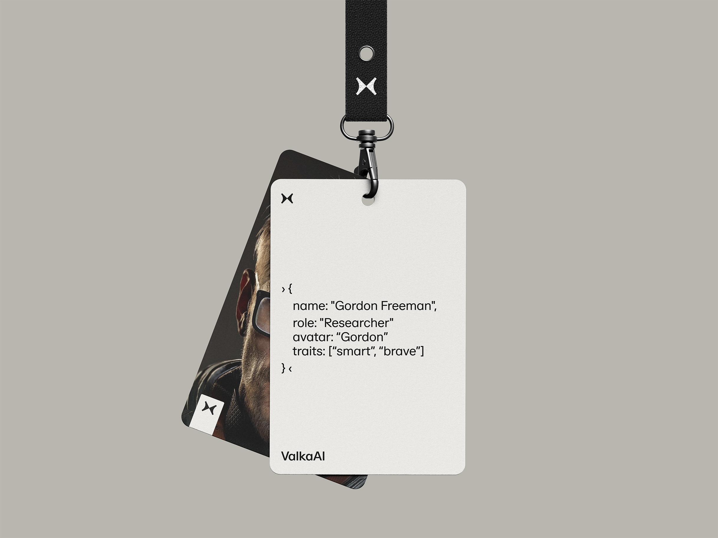 Two ID badges on a lanyard, the front badge displays text resembling a code snippet with name Gordon Freeman, role Researcher, and traits smart and brave, with ValkaAI logo.