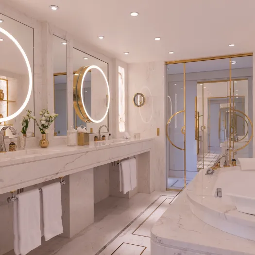 Salle de bain élégante avec marbre raffiné et baignoire spacieuse à l’Hôtel du Collectionneur à Paris.