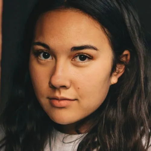 A close up of a person with long hair.