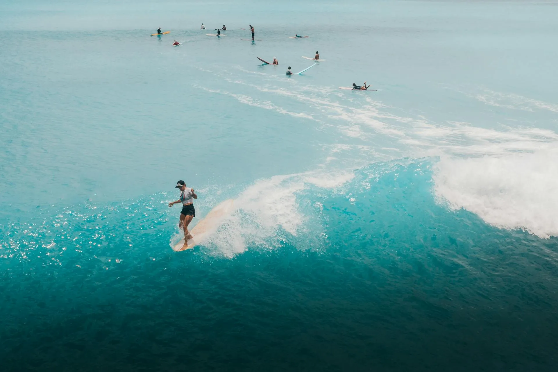 A man riding a wave on top of a surfboard.