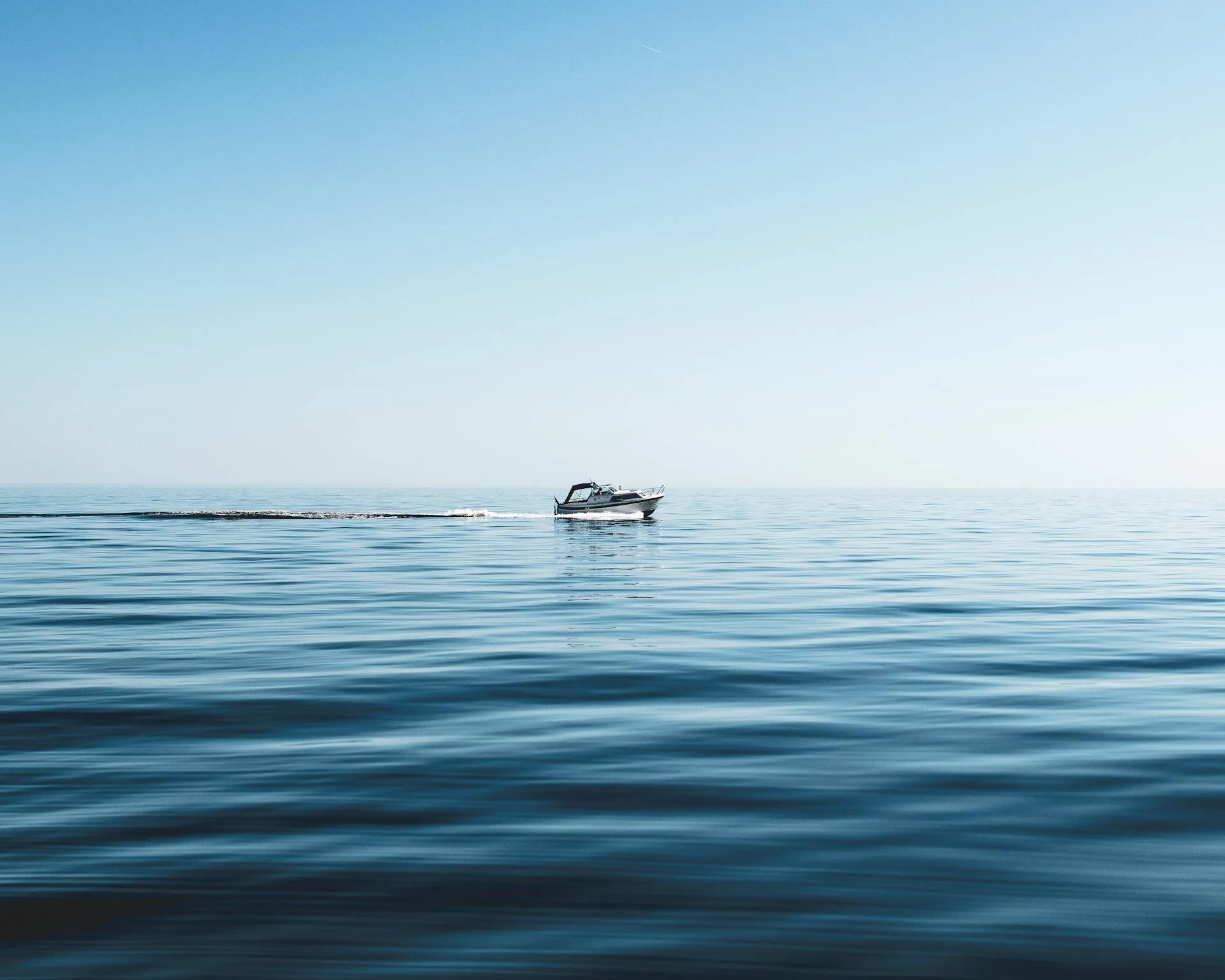 A boat floating on top of a large body of water.