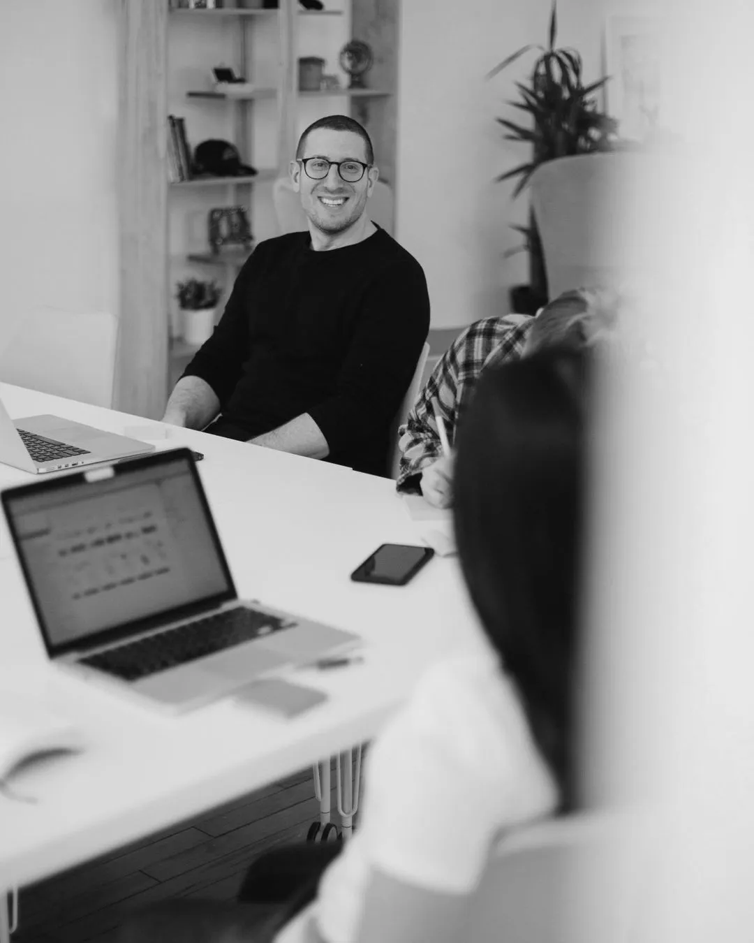 Two people in office meeting smiling