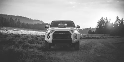 White Toyota SUV next to water