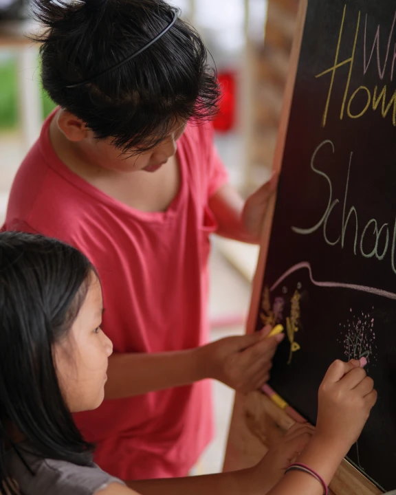 kids writing on board