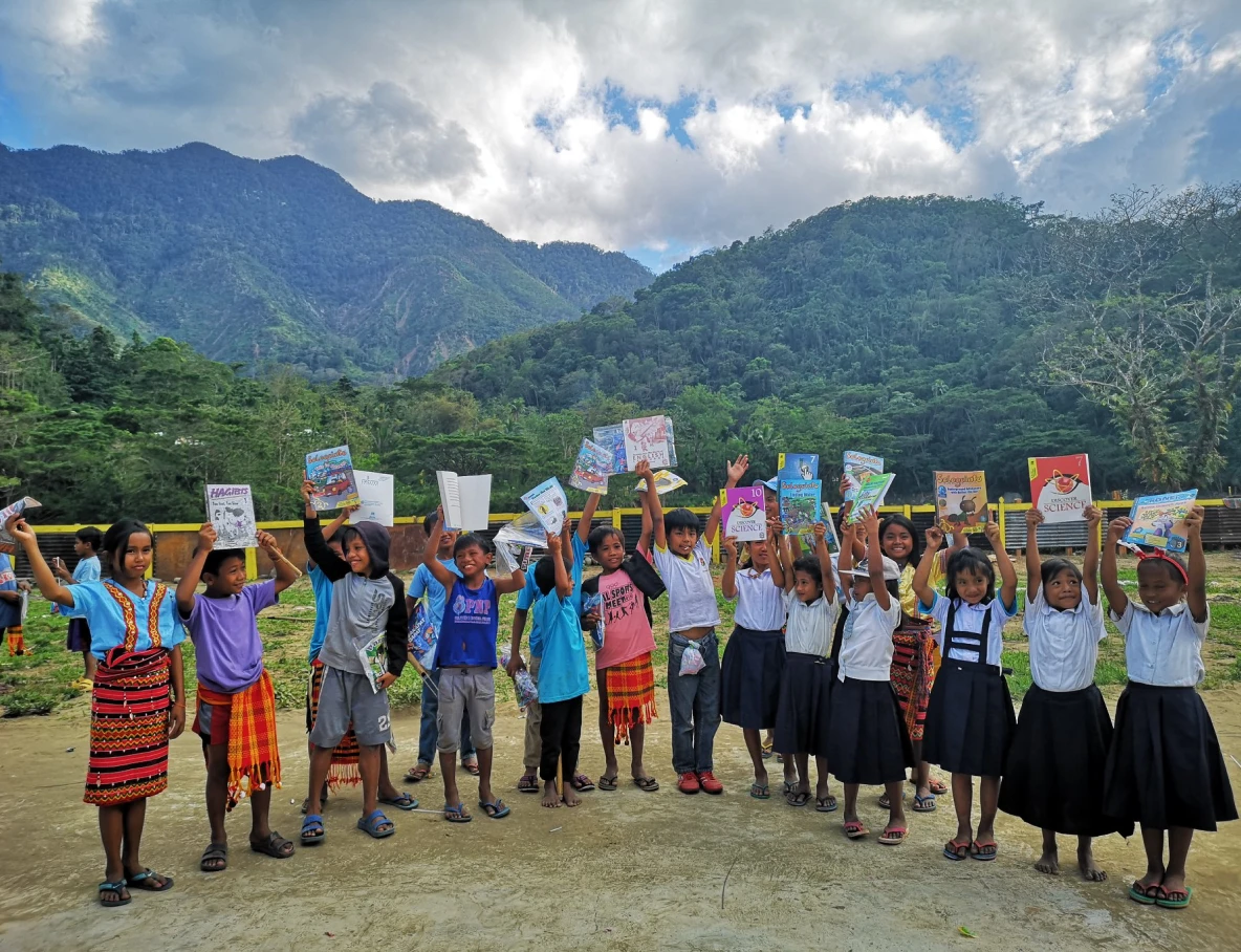 indigenous kids holding books