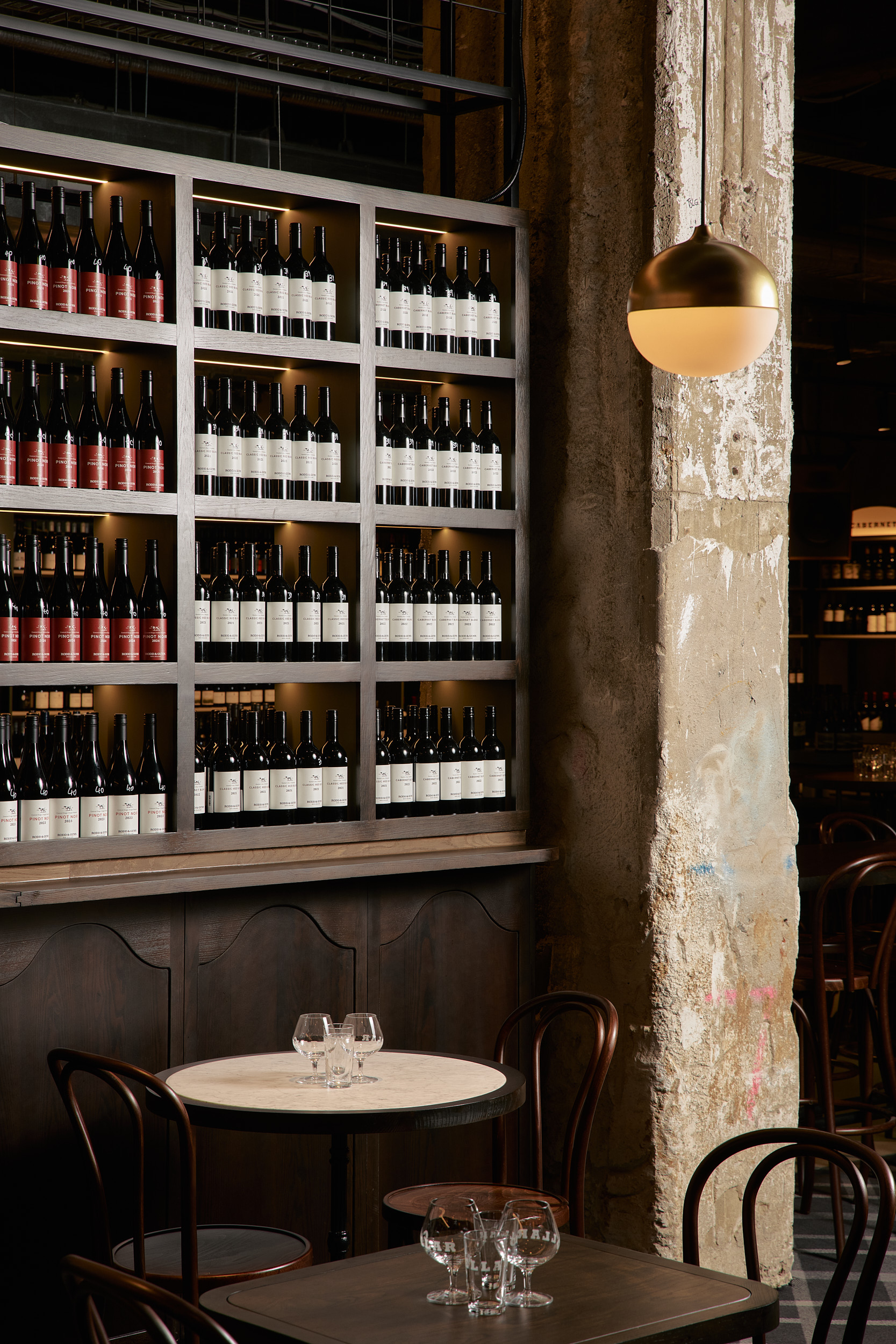 Wines Cupboards column table chairs glasses Rodd and Gunn in Melbourne. Photo by Jake Roden.