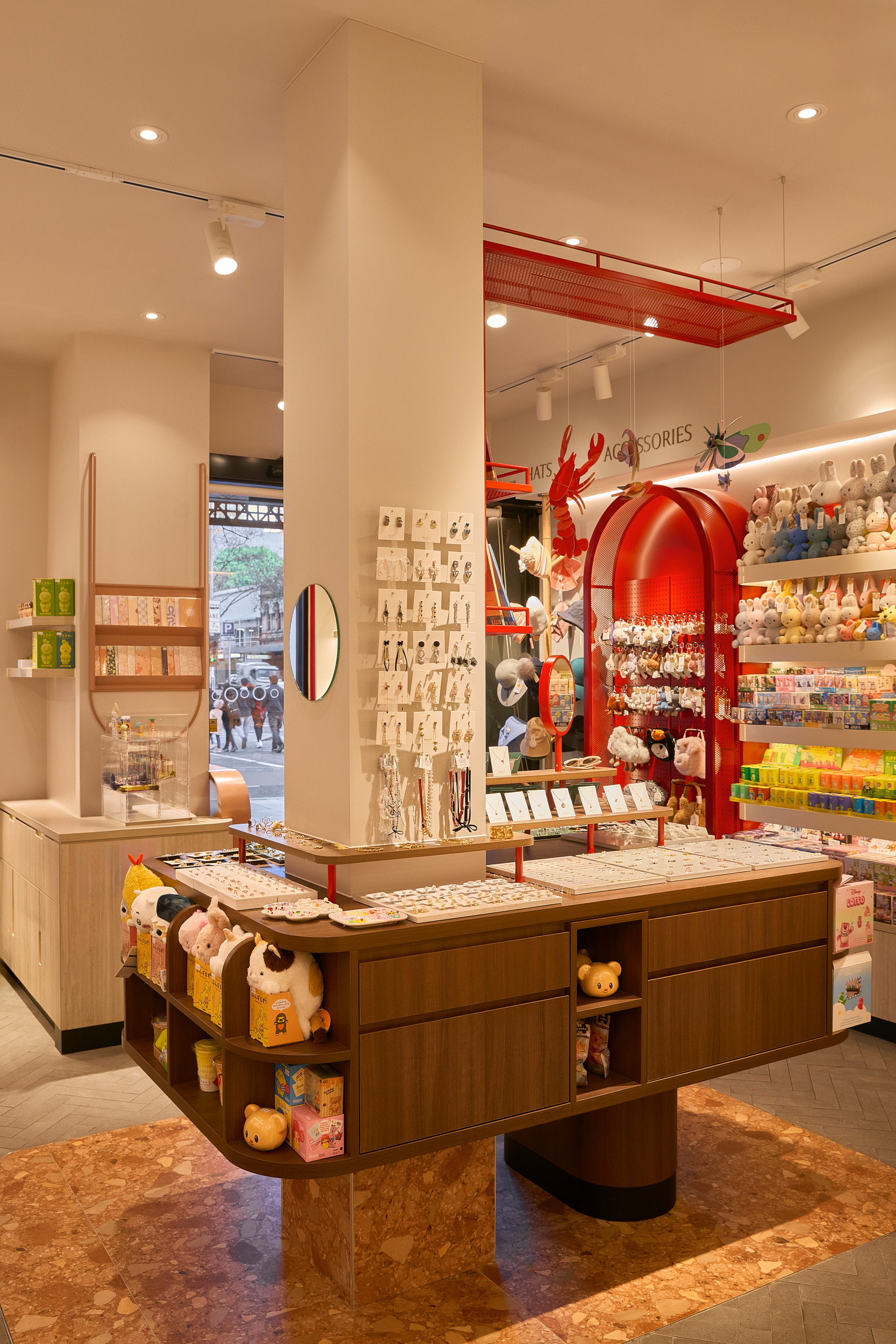 Column With Attached Cabinetry Below Drawers and Open Shelving Accessories Display on Back Wall in Mooii. Photo by Michael Gazzola, Jake Roden.