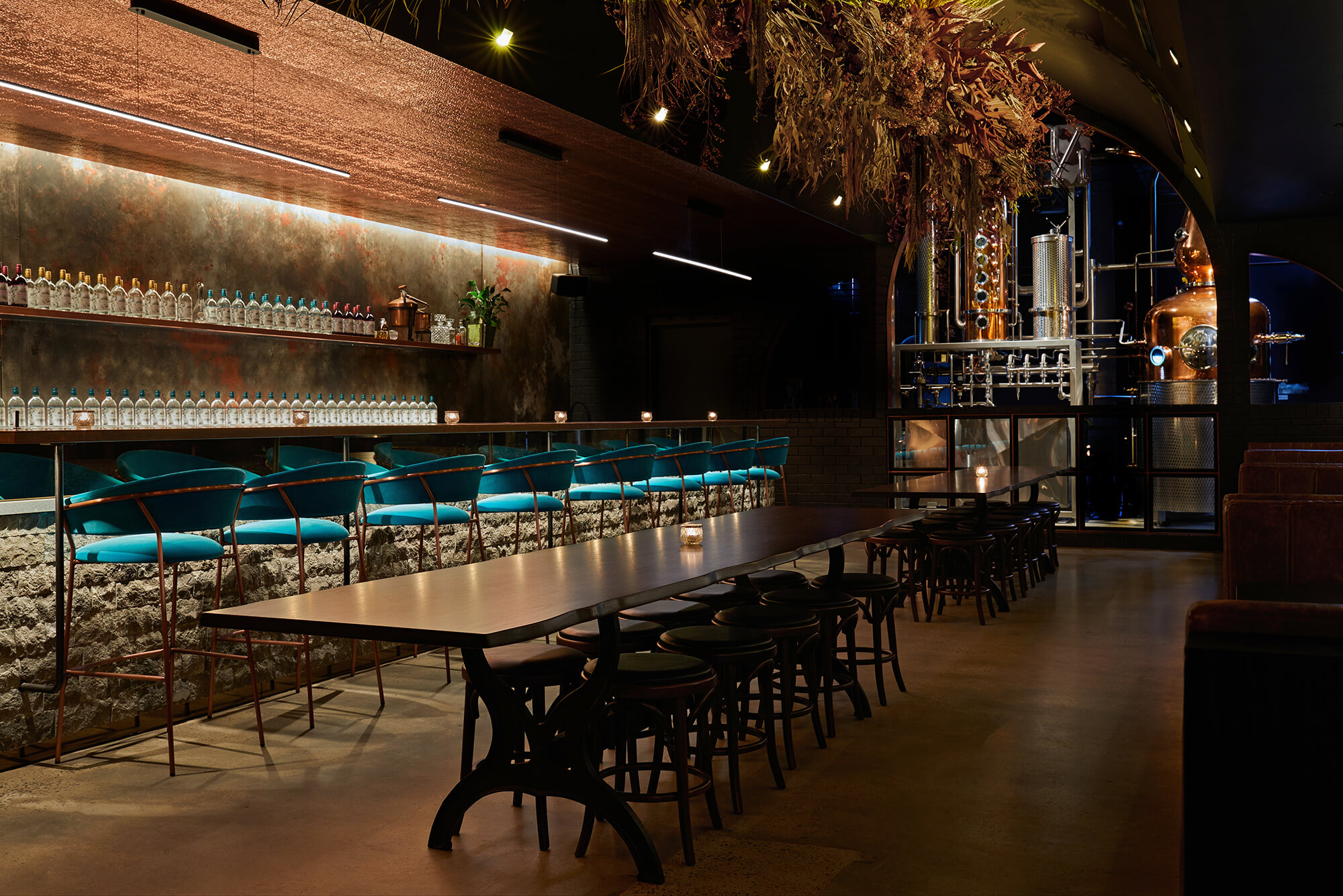 Refectory Table Dark Stools Masonry Bar Teal Seating Gilded Ceiling Copper Still Portal Dried Florals in Naught Distilling. Photo by Graham Denholm.