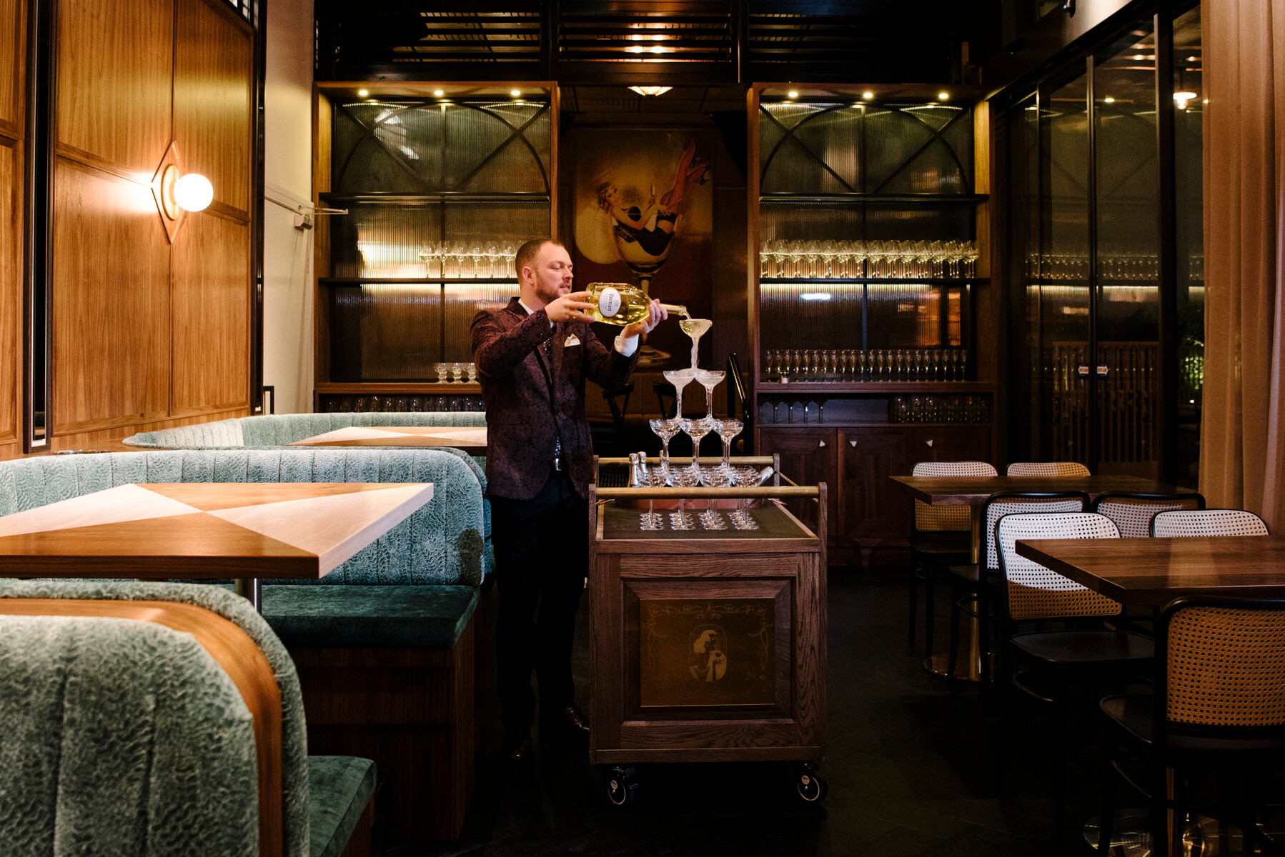 Champagne Tower Service Timber Drinks Trolley Sage Textured Booths Cane Chairs Fluted Glass Cabinets Globe Sconce in Nick & Nora’s. Photo by Ryan Sauer.