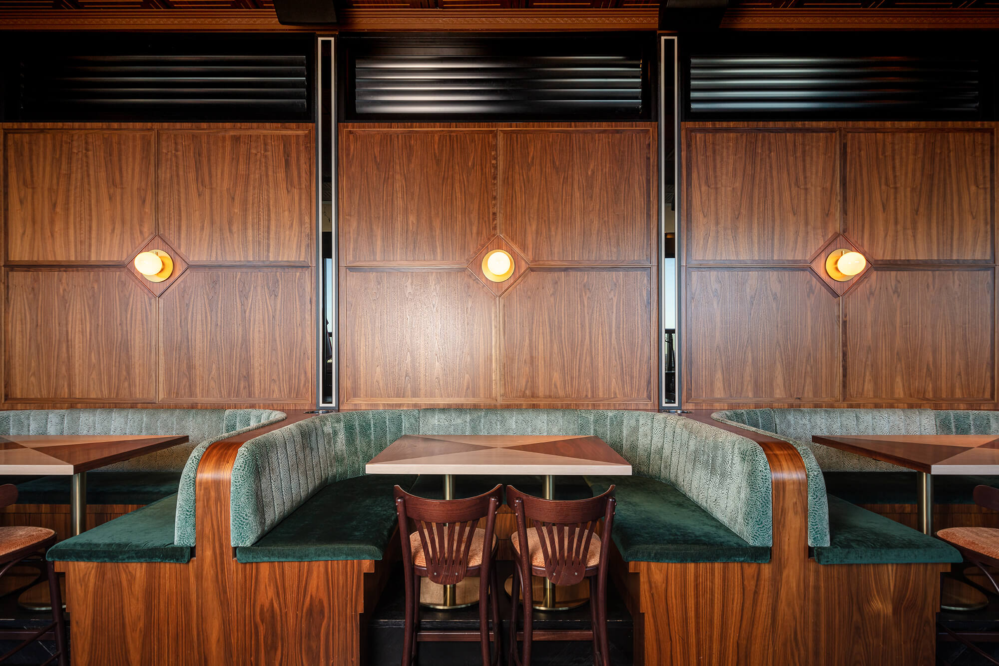 Walnut Wall Panelling Sage Animal-Print Booths Curved Timber Armrests Inset Brass Sconces Inlaid Dining Tables in Nick & Nora’s. Photo by Ryan Sauer.