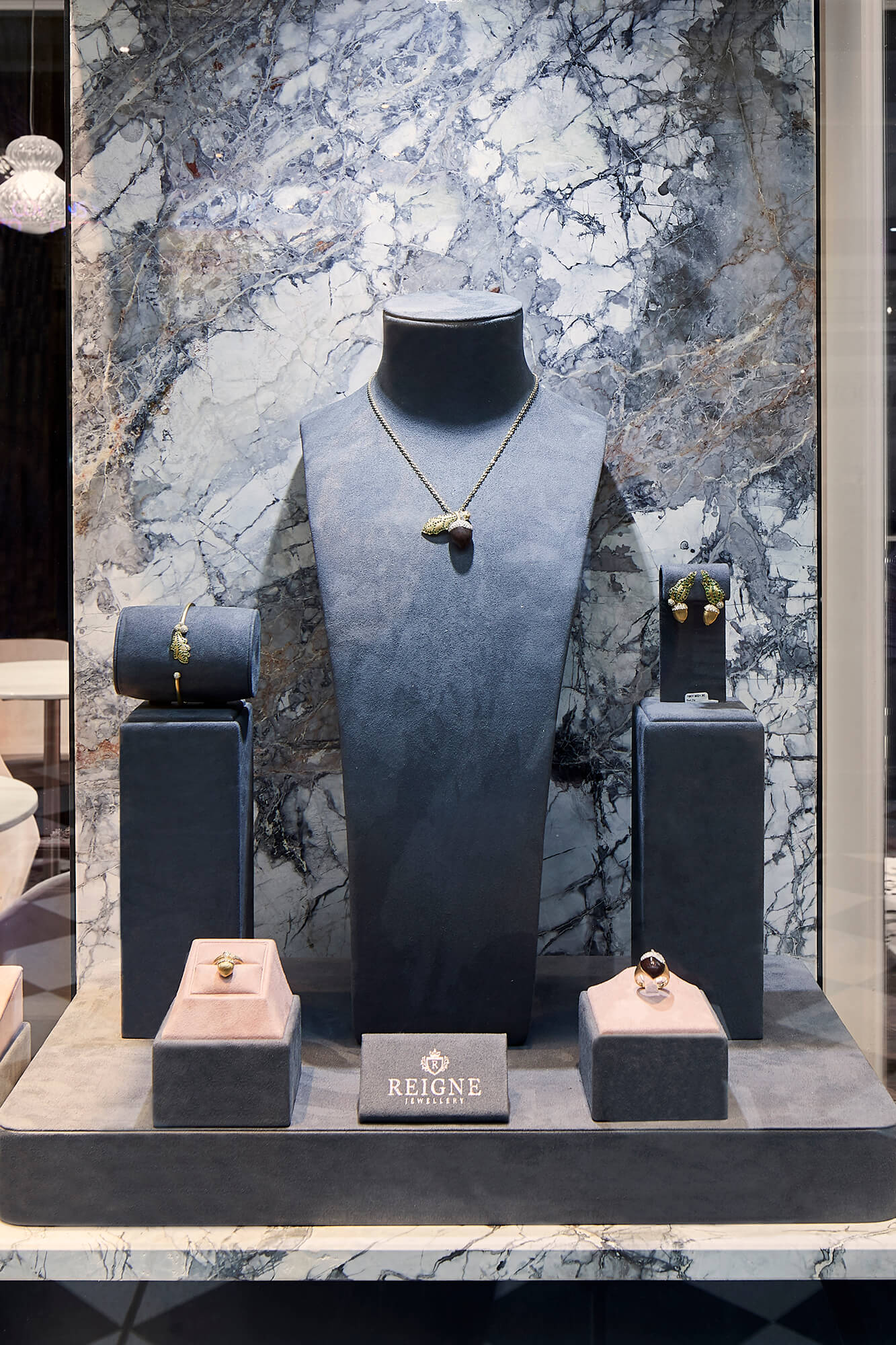 Blue Suede Bust Display Stone Veneer Backdrop Blush Jewelry Risers Acorn Motif Collection Marble Counter Detail in Reigne Jewellery. Photo by Nicole Reed.