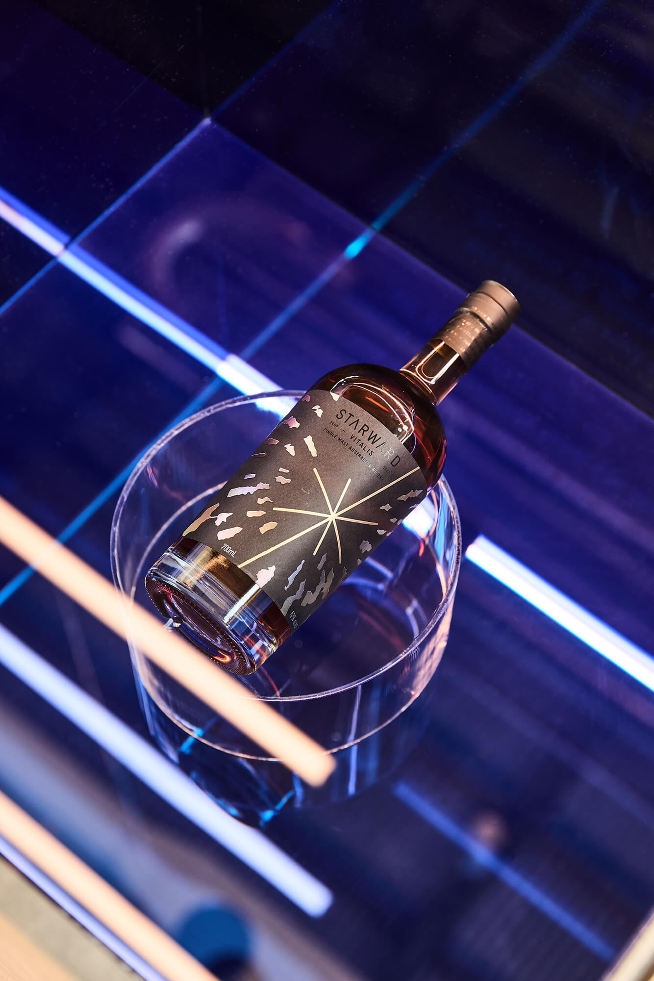 Cobalt Blue Tinted Glass Surface Acrylic Cylinder Riser Linear LED Accents Starward Vitalis Bottle Curation High-Gloss Finish in Starward. Photo by James Geer.