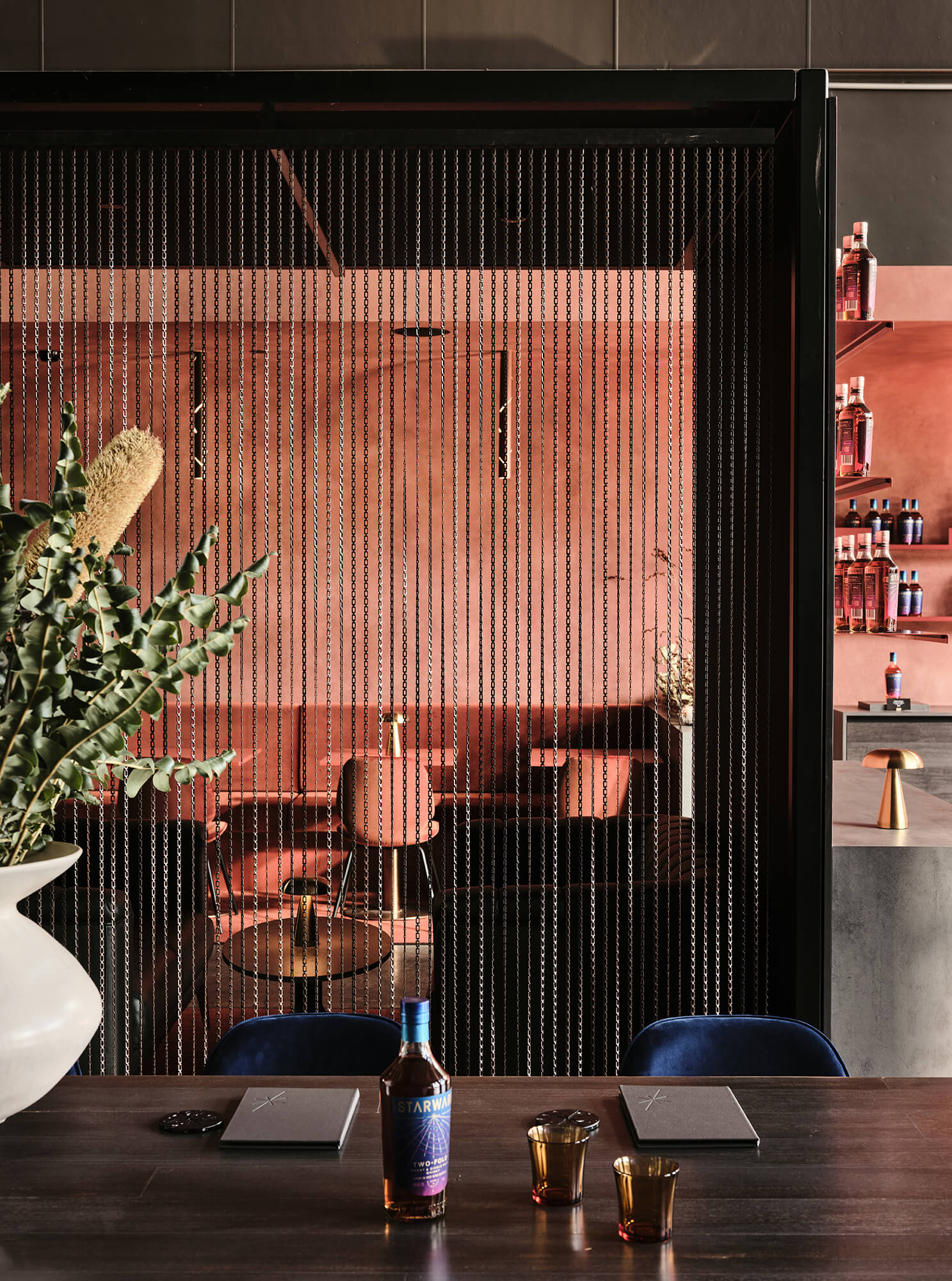 Bronze Chain Link Screening Terracotta Rendered Walls Blue Velvet Seating Gold Dome Table Lamps Sophisticated Industrial Layering in Starward. Photo by James Geer.