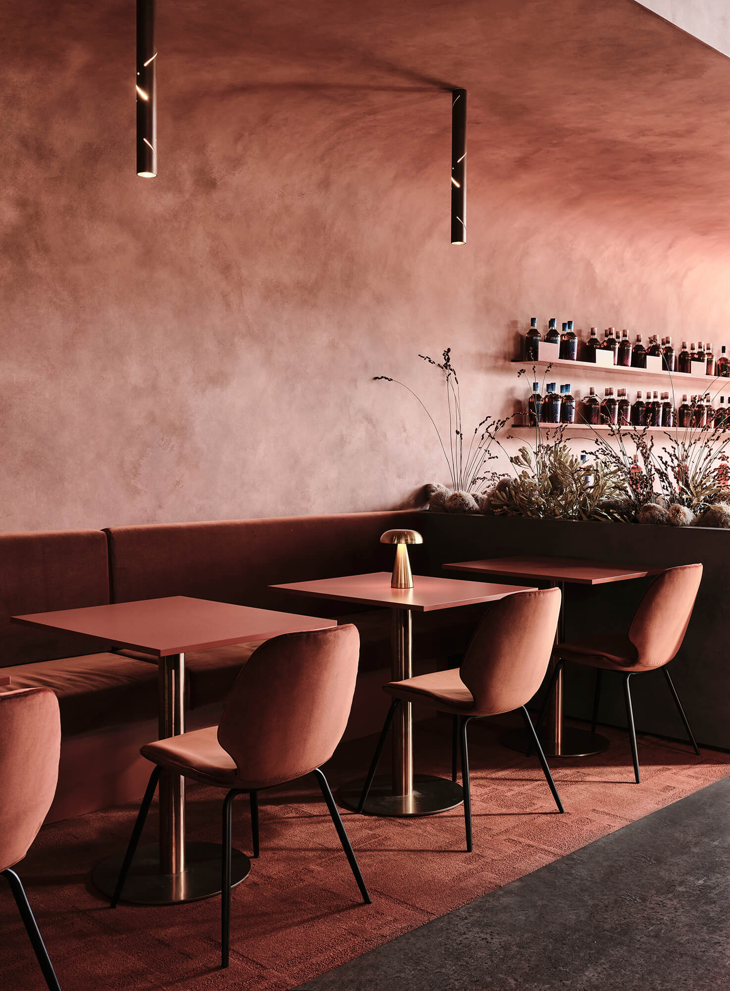 Curved Terracotta Stucco Ceiling Velvet Banquette Seating Clay-Toned Chairs Gold Dome Table Lamp Perforated Black Pendants in Starward. Photo by James Geer. 