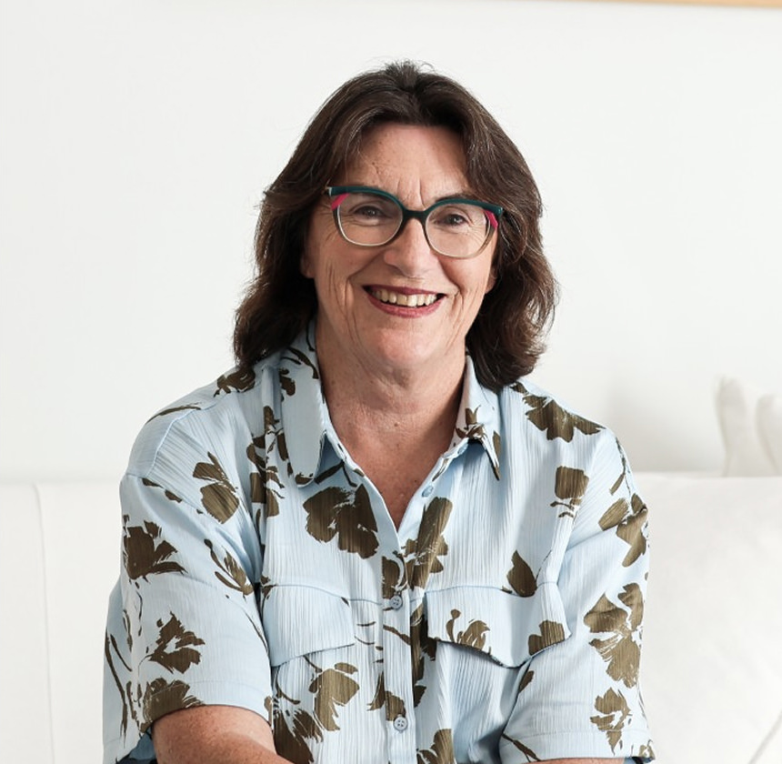 Portrait of Liv, woman in white patterned shirt smiling