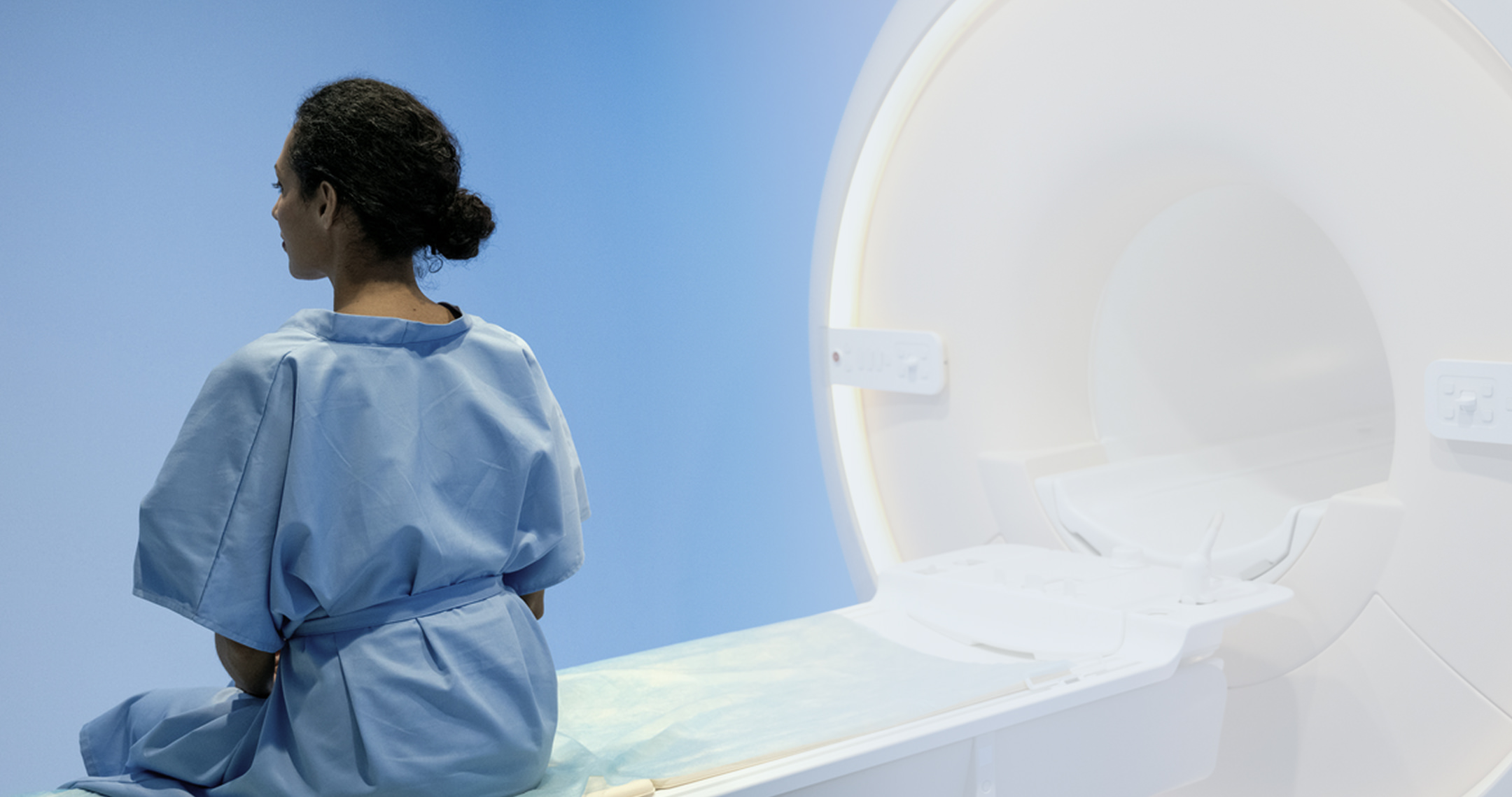 MRI technician preparing machine in medical room
