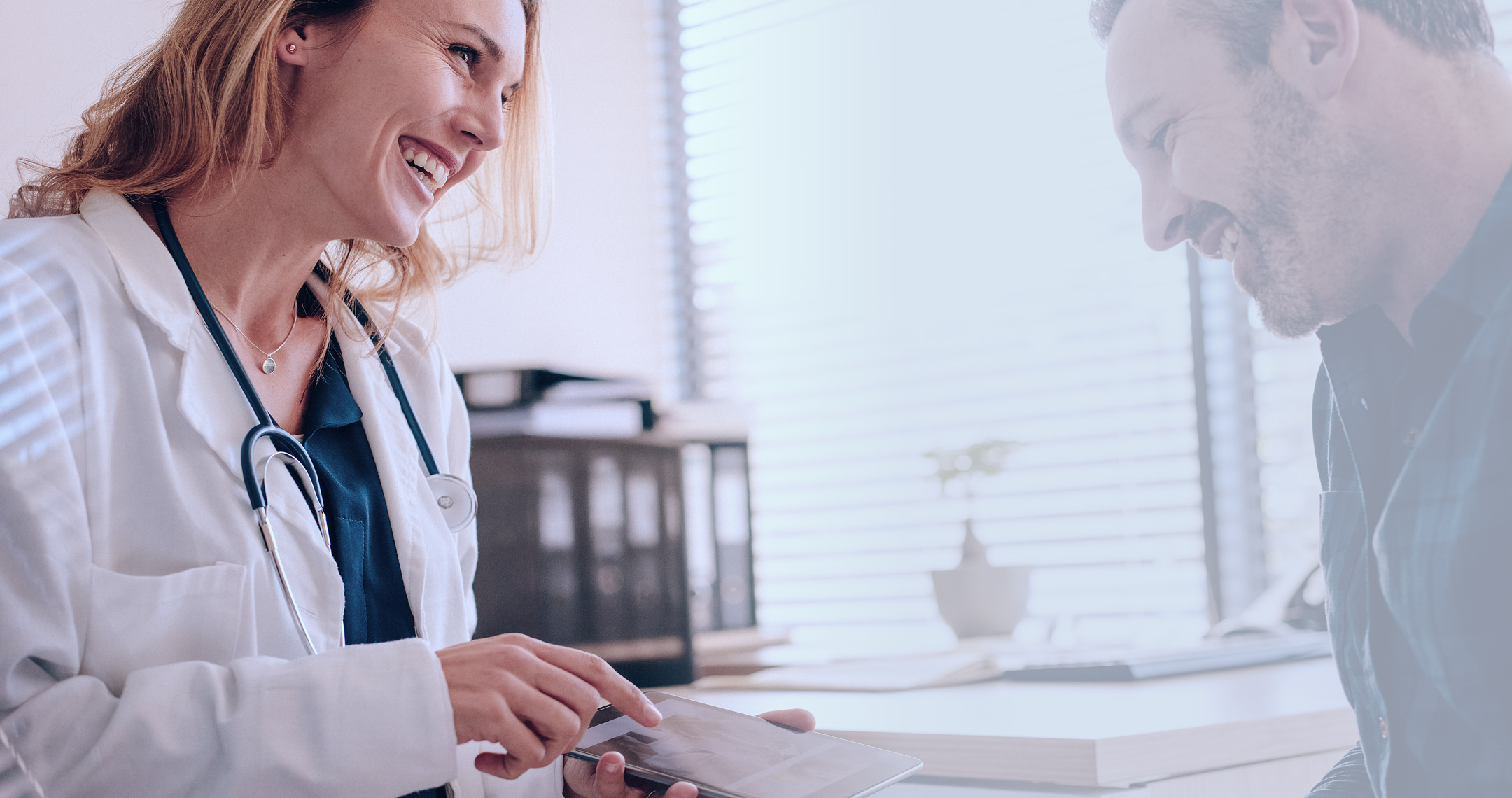 Female doctor consulting with elderly patient in clinic