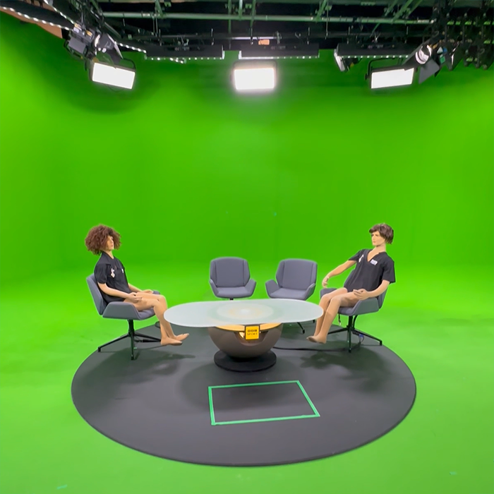 The physical elements of the BBC's greenscreen studio are shown here - mat, desk and chairs. For testing, a pair of posable mannequins are often used. These have become know as Kylie and Jason.