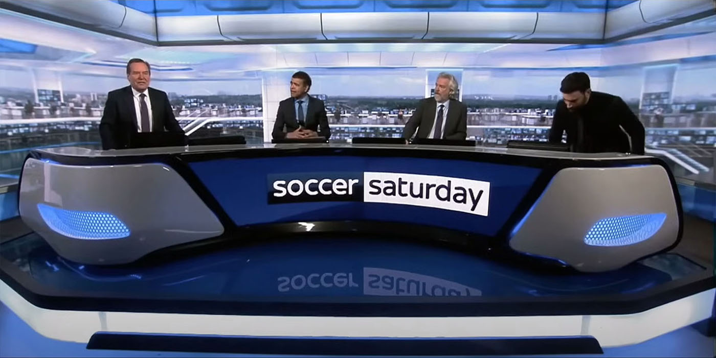 A scene from Ted Lasso in which Roy Kent appears as a reluctant pundit on Sky Sports Soccer Saturday. The set design features the dgital backdrop created y Jim Mann at Lightwell