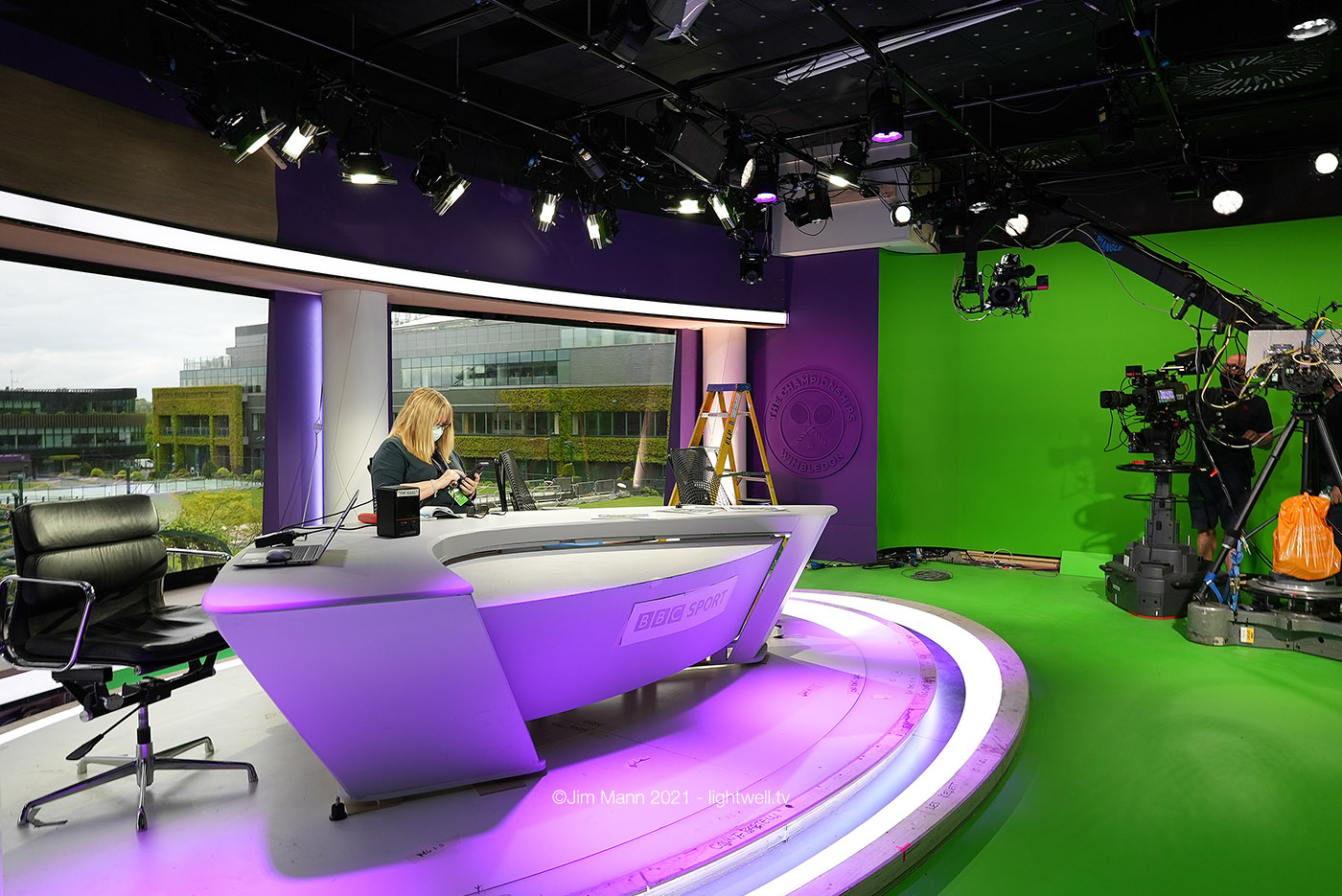 Photography of the Wimbledon studio during construction. The greenscreen floor and walls are clear to see, as is the real ceiling which features lights and pipework, unlke the sleek design of the virtual set 