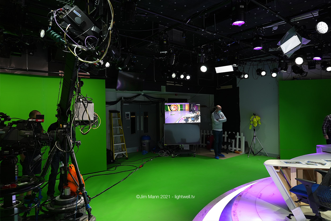 A view from behind the desk, looking back to the rear wall of the studio. Where there is no green, the studio will be hidden using masks.
