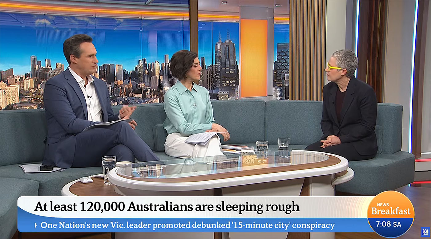 Wide shot of two presenters and guest sat in the sofa area of the ABC Breakfast studio. The digital backdrops we created are displayed on the large format LED screens located behind the sofa.