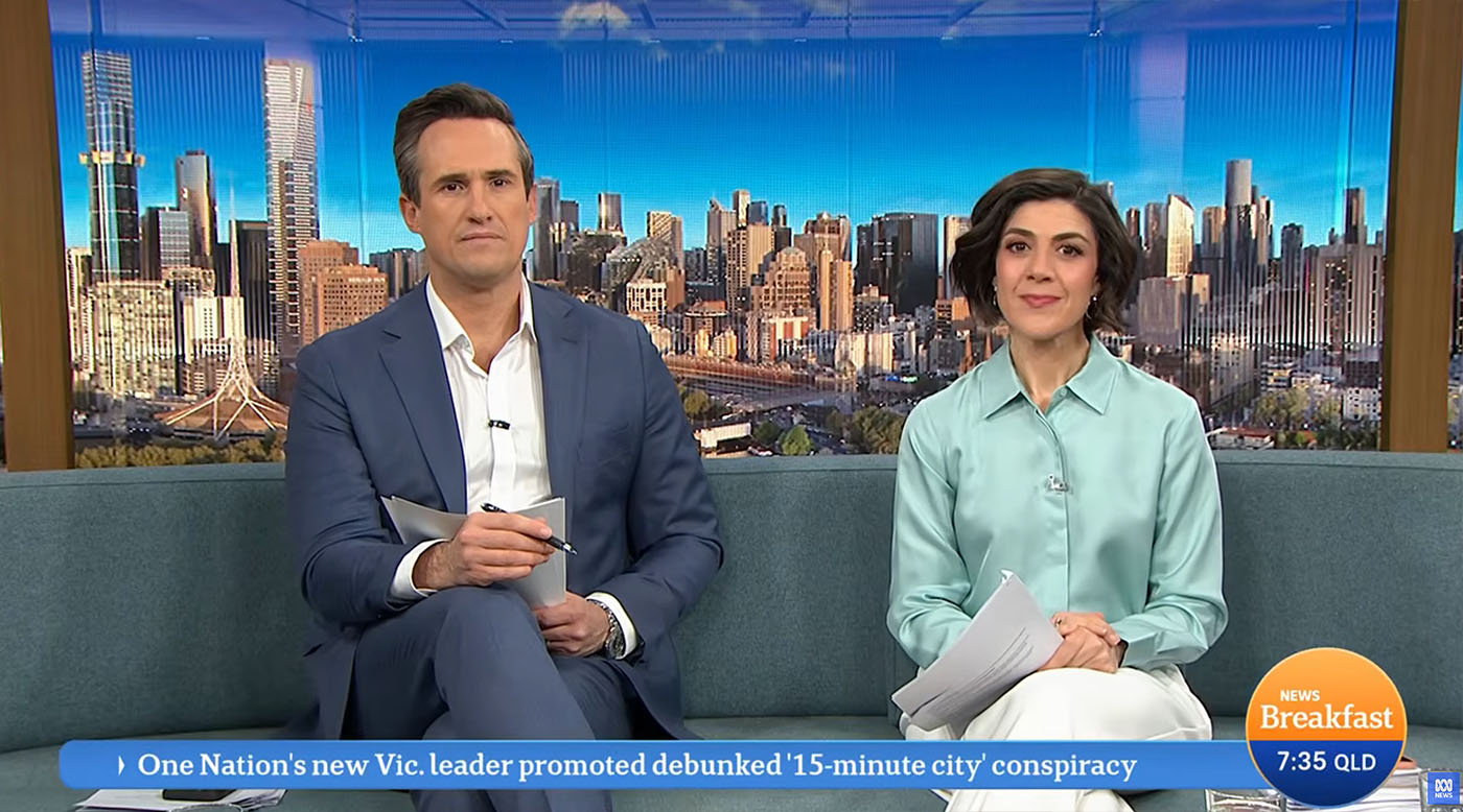 Shot of two presenters sat in the sofa area of the ABC Breakfast studio. The digital backdrops we created are displayed on the large format LED screens located behind the sofa.