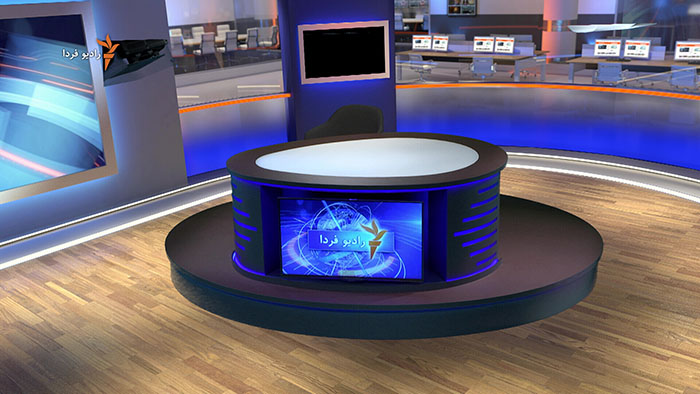 The desk sat within the virtual studio and newsroom. The Tricaster system has been used to "key" out the green colour and this as been replaced by a virtual set.