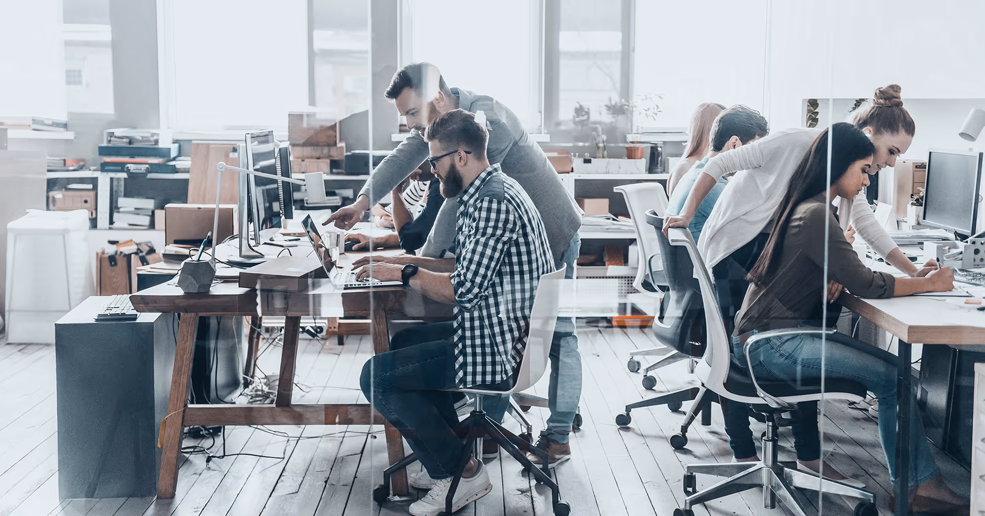 People working on computers in an office 1.91x1