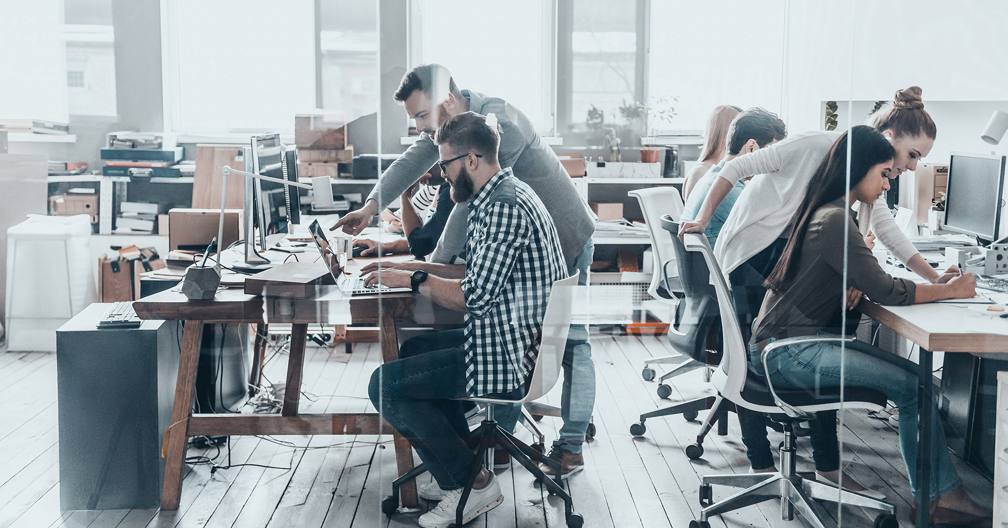 People working on computers in an office 1.91x1