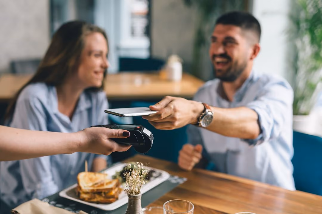 Person paying with a card on a payment machine