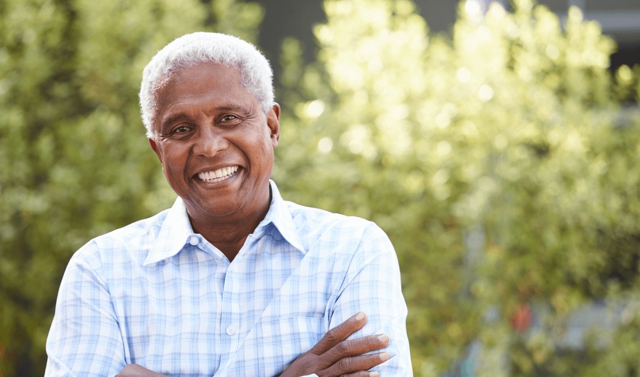 Smiling senior man enjoying renewed confidence after dental implants, highlighting care from the best dentist for dental implants in Miami Beach