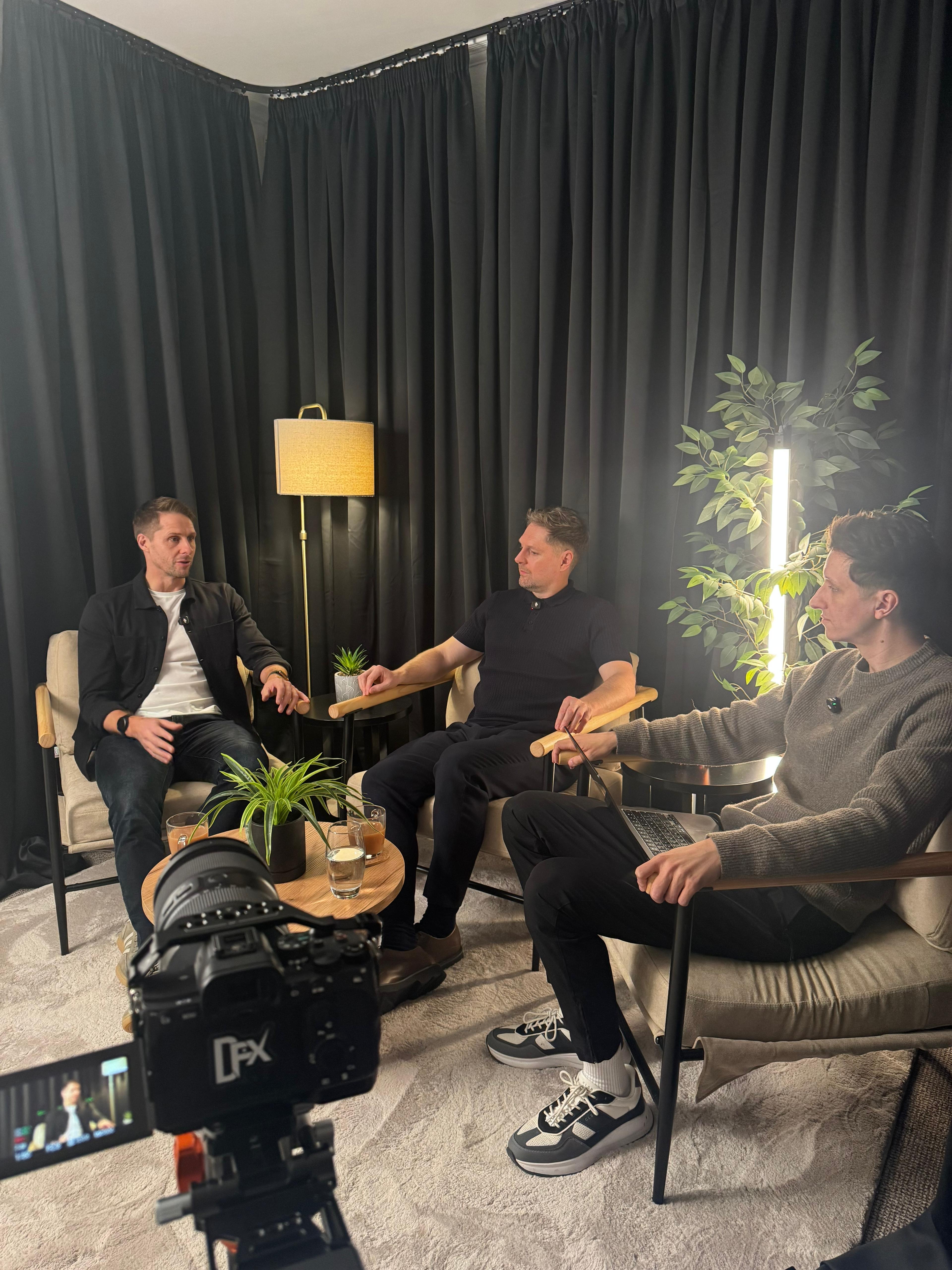 a group of people filming content in a podcast setting 