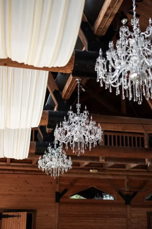 Chandeliers hang from a vaulted wood ceiling in a large venue that's rented for weddings, corporate events, and more in Skagit County.