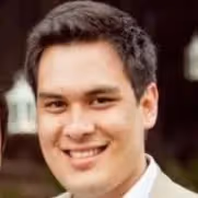 A man wearing a suit and smiling for the camera. - Wellinks Images