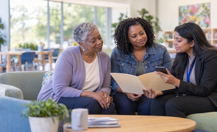 Family members meeting with a community resource navigator about medical-cost assistance