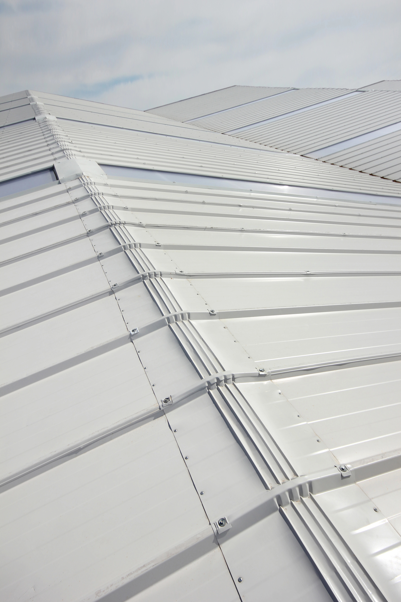 white metal roofing with large vertical windows for natural light in between