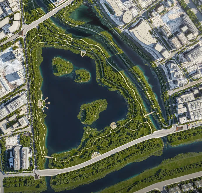 A 3D aerial rendering of a landscaped urban park with water features, islands, walking paths, and a surrounding urban environment, showcasing a harmonious mix of green space and urban development.