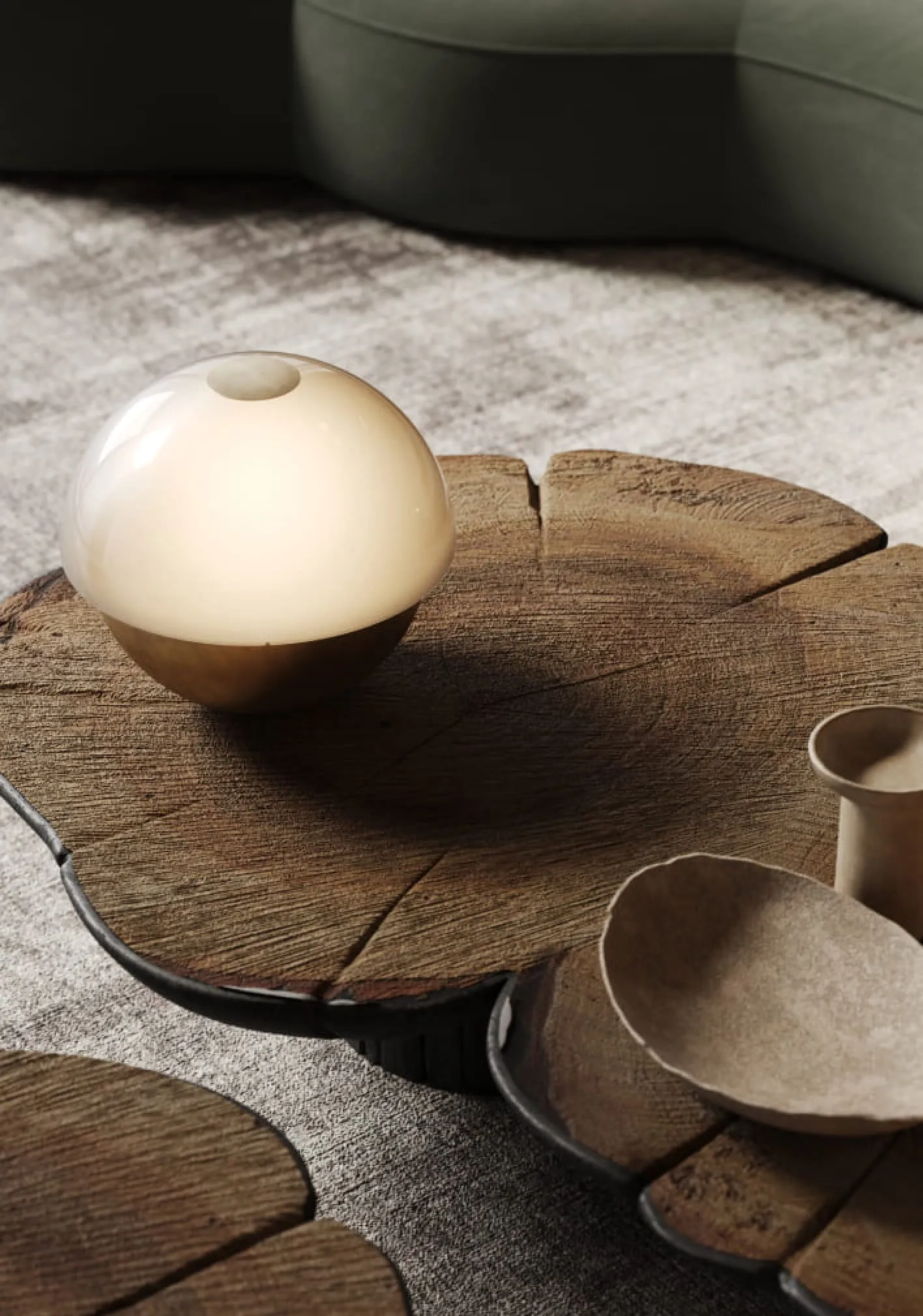  A striking 3D product rendering of a modern floor lamp with curved metallic shapes, placed in a dimly lit, cave-like environment.