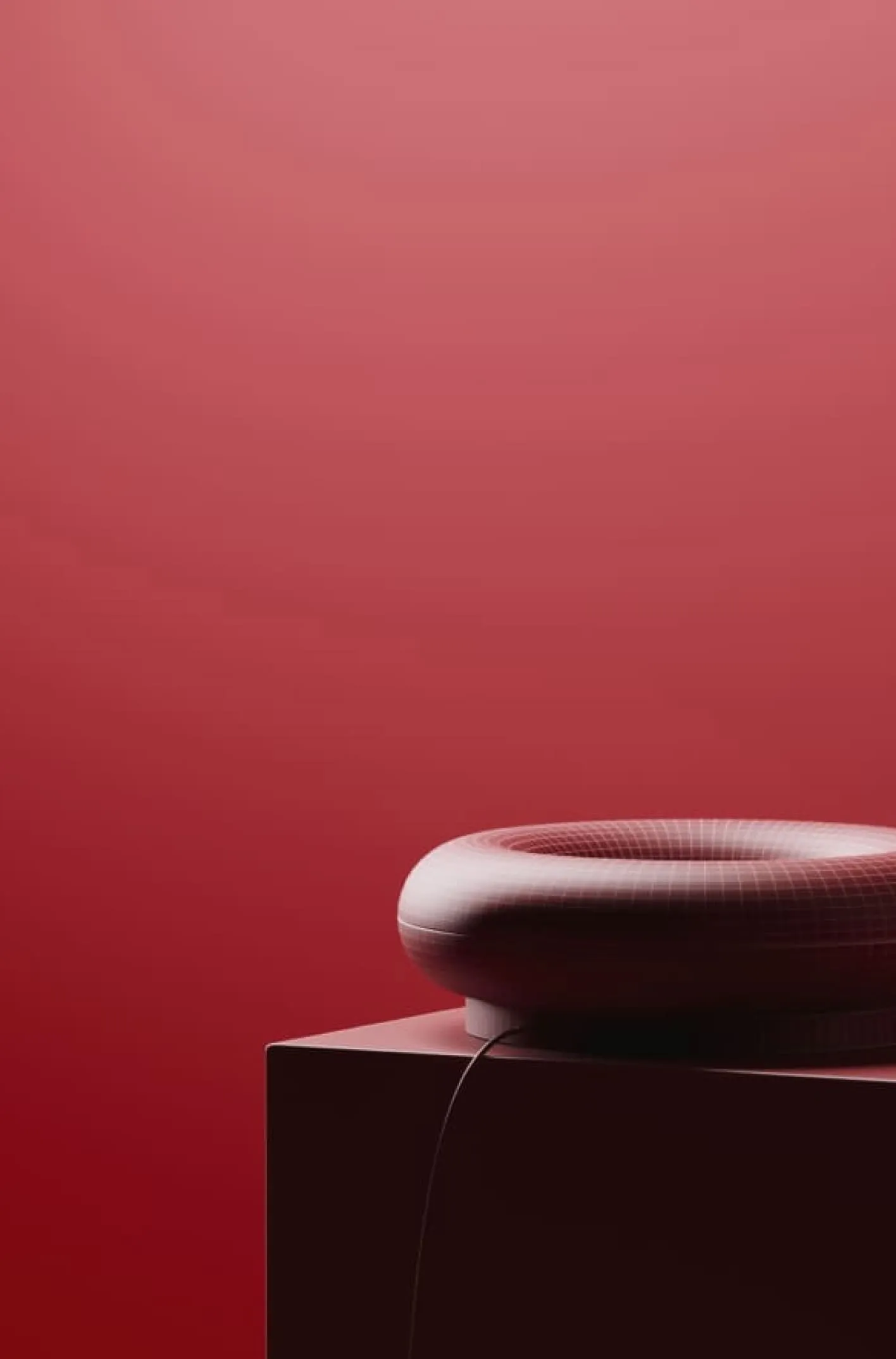The same donut speaker presented in red wireframe on a red pedestal — demonstrating 3D prototyping visualization from Product 3D Modeling Services.